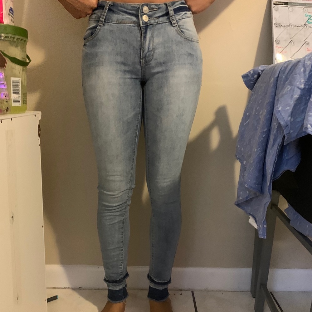 Blue jeans with distressed thing on the bottom